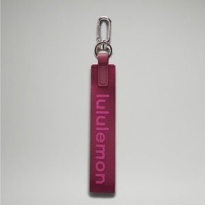 BRAND NEW Lululemon never lost keychain in wine berry/sonic pink